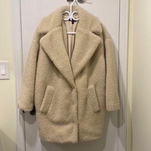 A warm cream/ off white fur coat. Slouch/baggy great for layering.